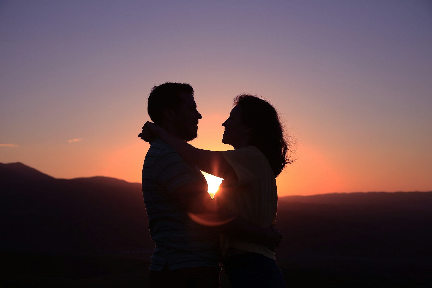 A couple embracing at sunset — beginning a life together